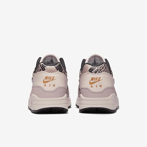 Light pink Air sneakers with Nike heel branding and purple patterned collar