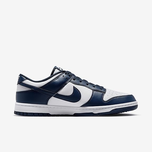 Nike Dunk Low low-top sneakers with white panels, navy Swoosh, and lace-up closure