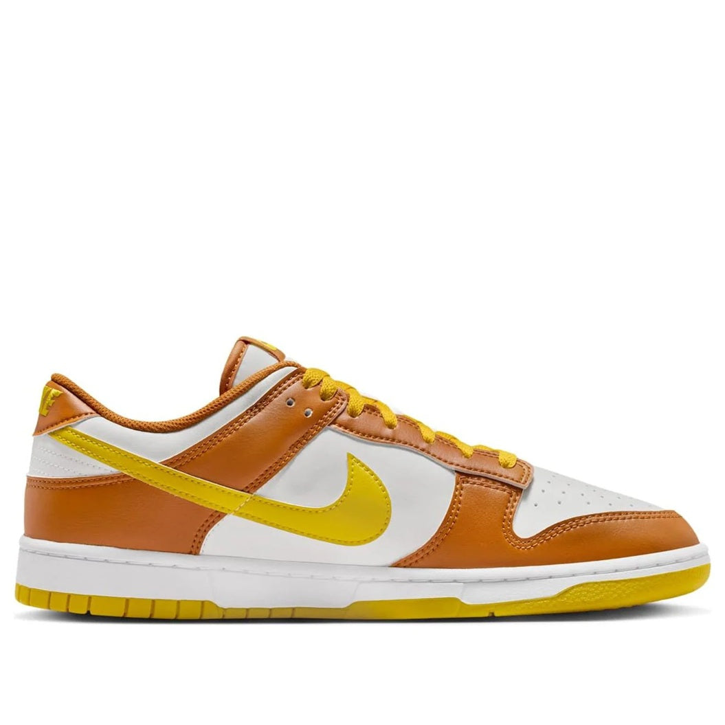 Men's Nike Dunk Low sneakers, side view, brown leather with white panels and yellow swoosh