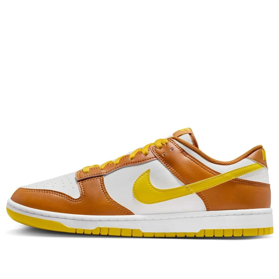 Men's Nike Dunk Low sneakers in brown, white, and bright yellow with yellow laces