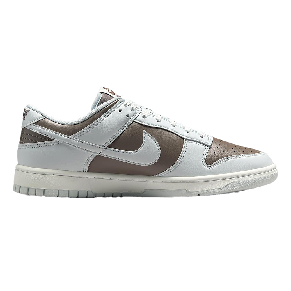 Low-top sneakers side profile with oversized Nike swoosh and brown leather inserts
