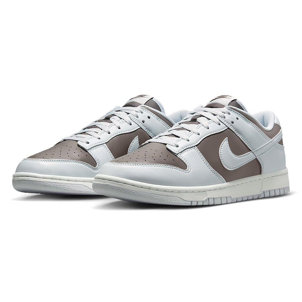 Pair of low-top sneakers in light gray with brown accents and Nike swooshes