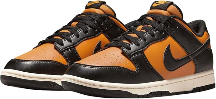 Pair of orange and black lace-up Nike low-top sneakers with white midsole