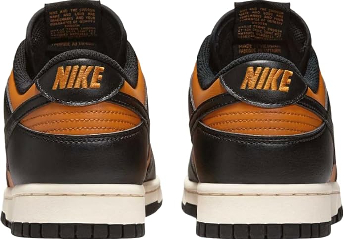 Back view of orange and black sneakers with Nike heel logo and orange lining
