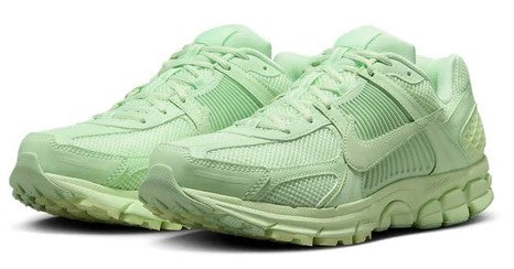 Men's Nike Vapor green running shoes, side view with cushioned sole and lace-up.
