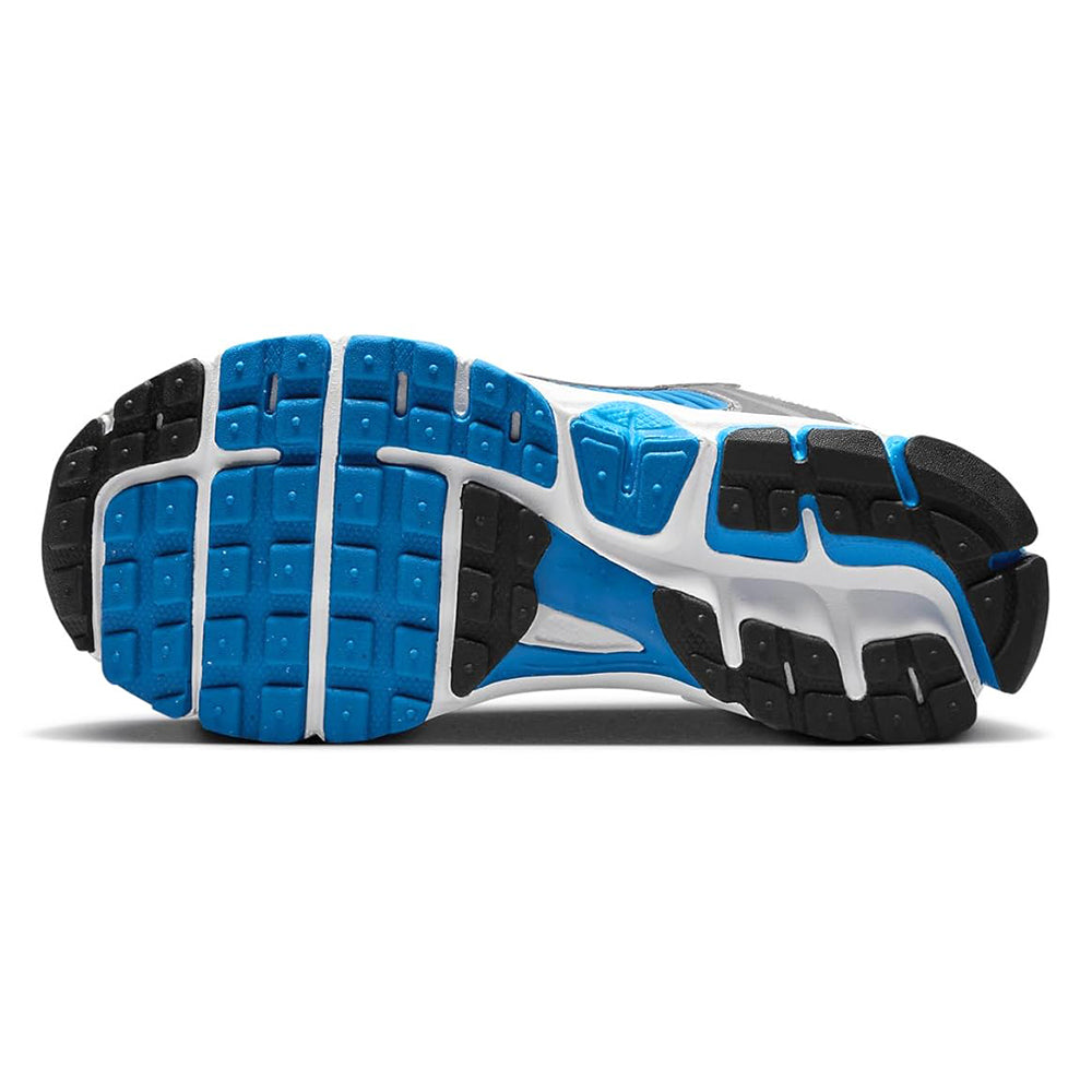 Big kid Nike Vomero 5 outsole view, blue traction pods with black and white tread