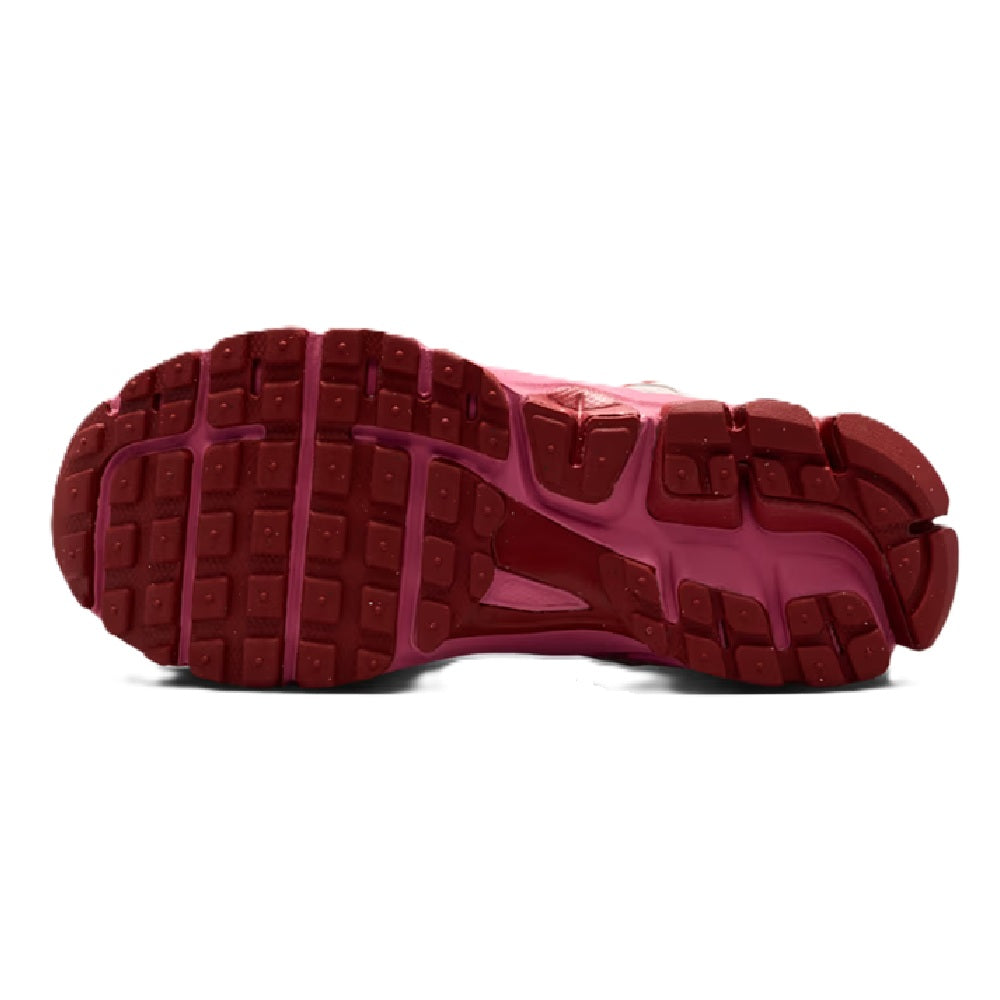 Kids sneaker outsole with textured tread in dark pink and red tones