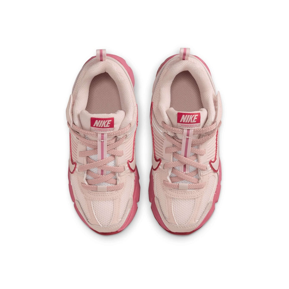 Kids' running shoes with pink laces, Nike logo on tongue, and padded collar