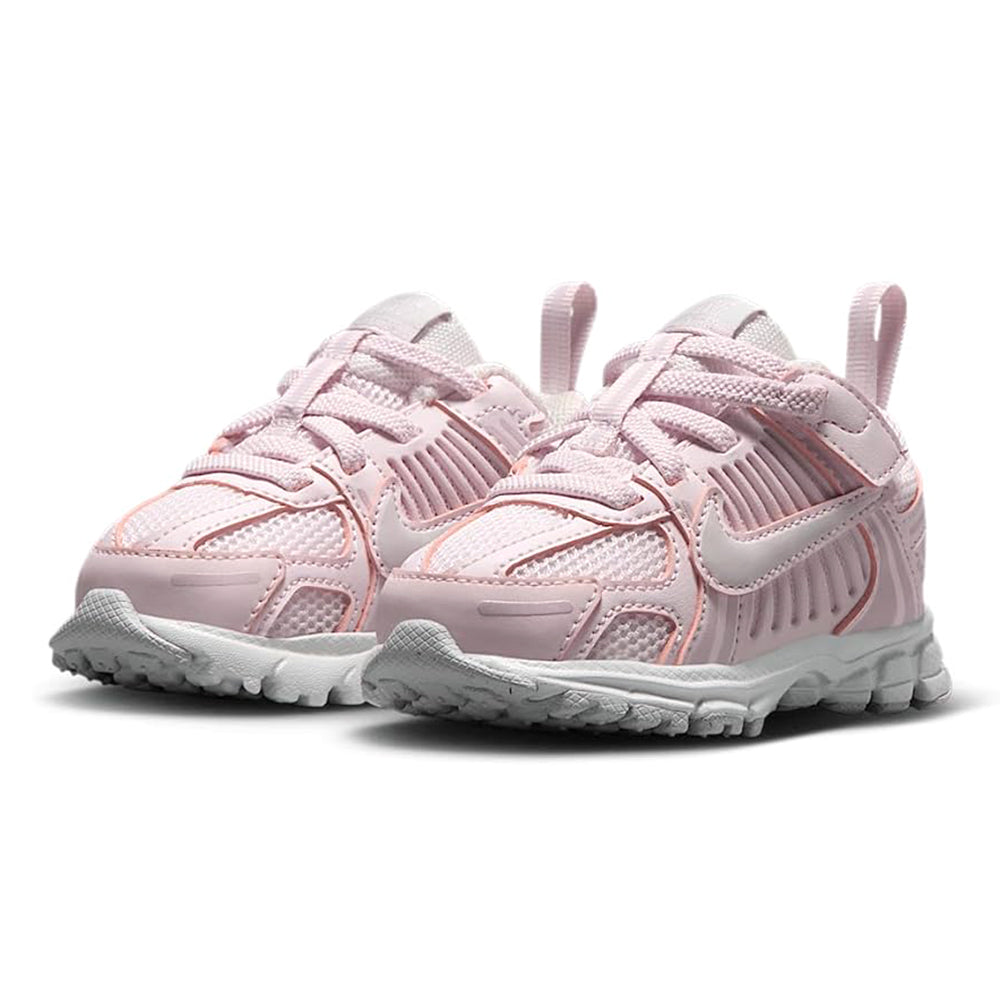 Toddler pink Nike running shoes with ridged midsole and lace closure