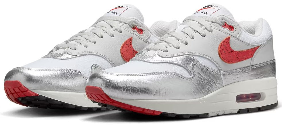 Pair of men's Nike Air Max 1 PRM sneakers, white with red accents and Air cushioning