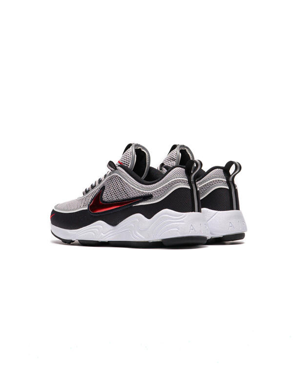 Running sneaker heel view with metallic silver upper, black collar, red Swoosh, white midsole