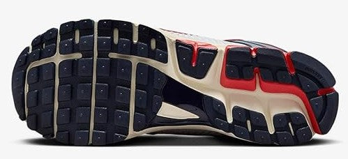 Men's Nike running shoe outsole view with dark tread and red heel detail
