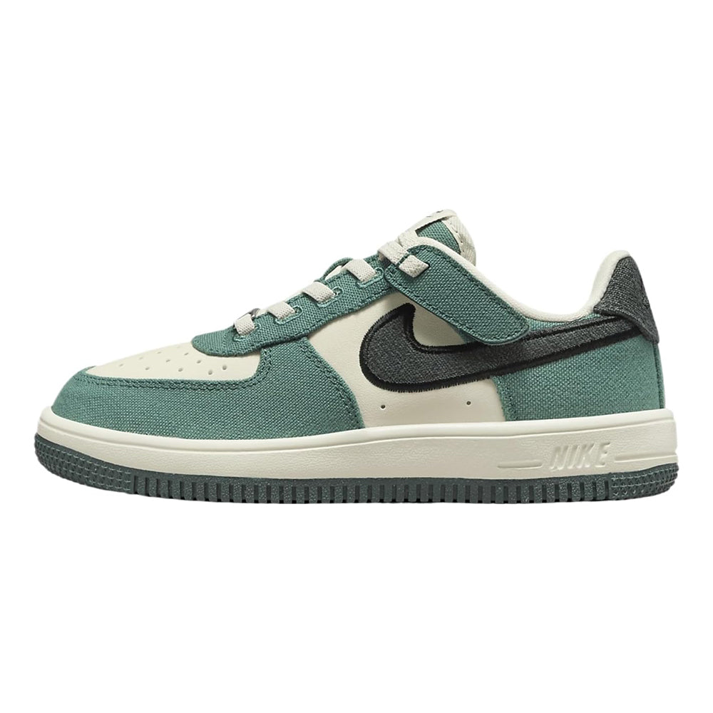 Kids low-top sneakers in teal green with cream panels and black Nike swoosh