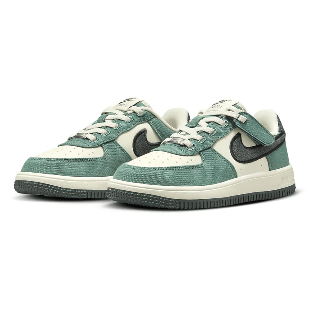 Pair of kids low-top sneakers with teal green uppers, cream toe, and black swoosh