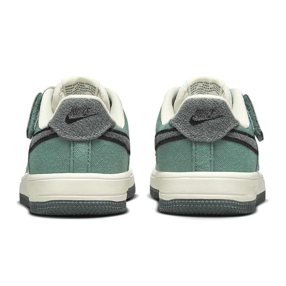 Kids sneakers heel view with teal fabric, cream midsole, and black heel tabs