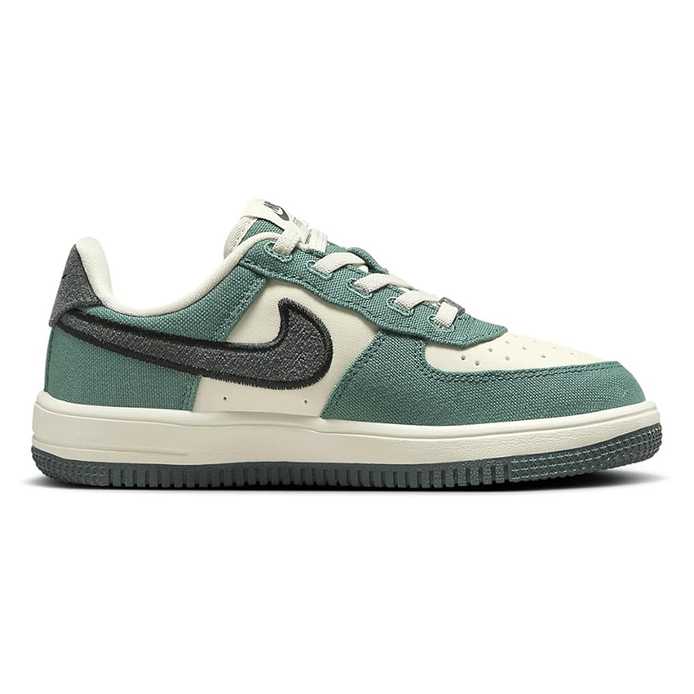 Kids low-top sneakers side view with teal upper, cream stripe, and black swoosh