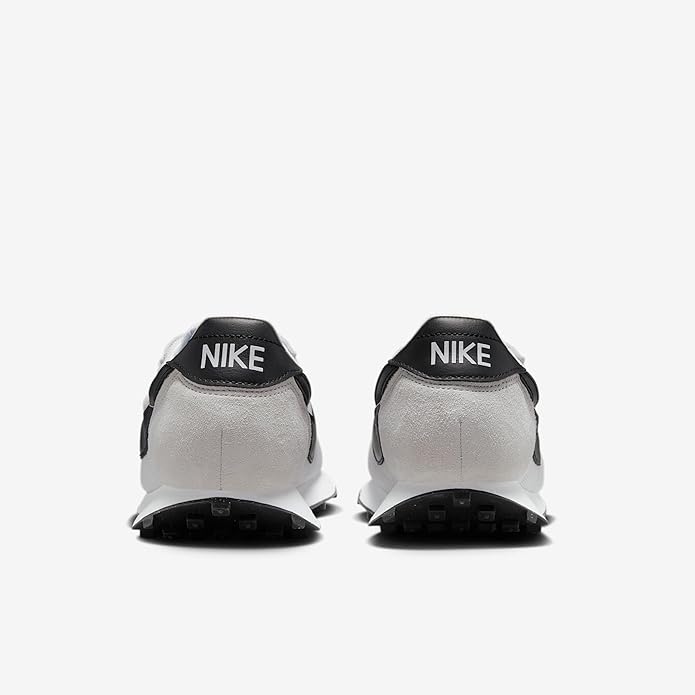Men's white sneakers with black heel tab showing NIKE text and black outsole