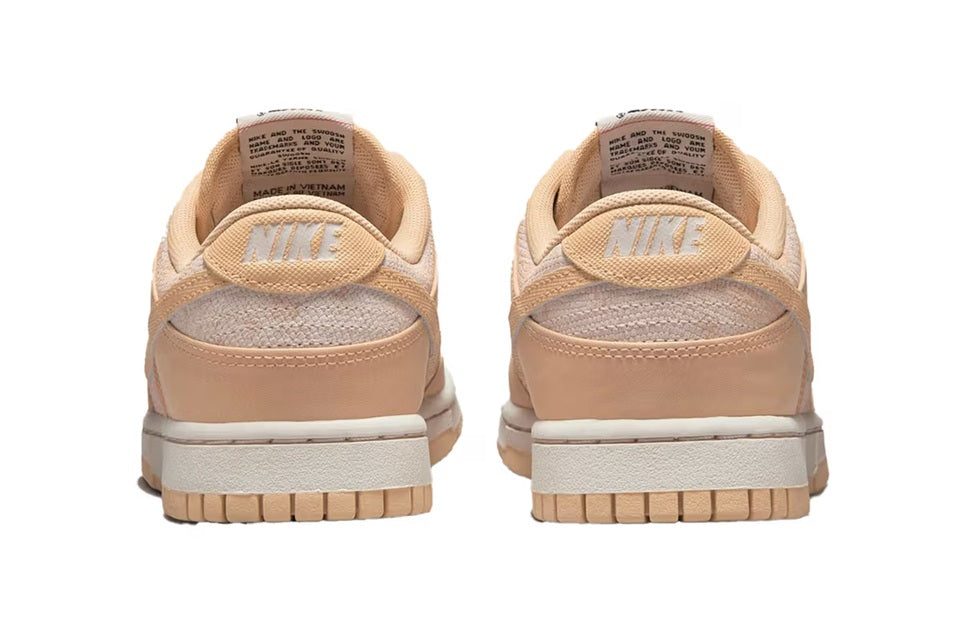 Women's Nike Dunk Low sneakers, tan heel with NIKE logo patch and padded collar