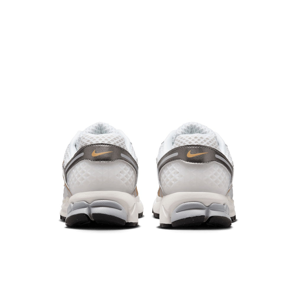 Pair of white running shoes with gray heel tabs, lace-up backs, cushioned outsole