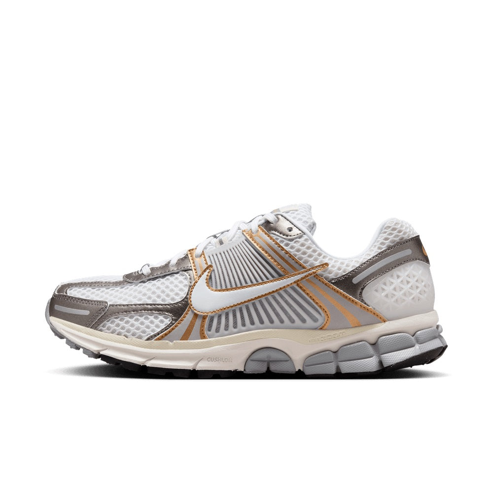 White mesh running shoe with gold swoosh, gray panels, lace-up design and thick midsole