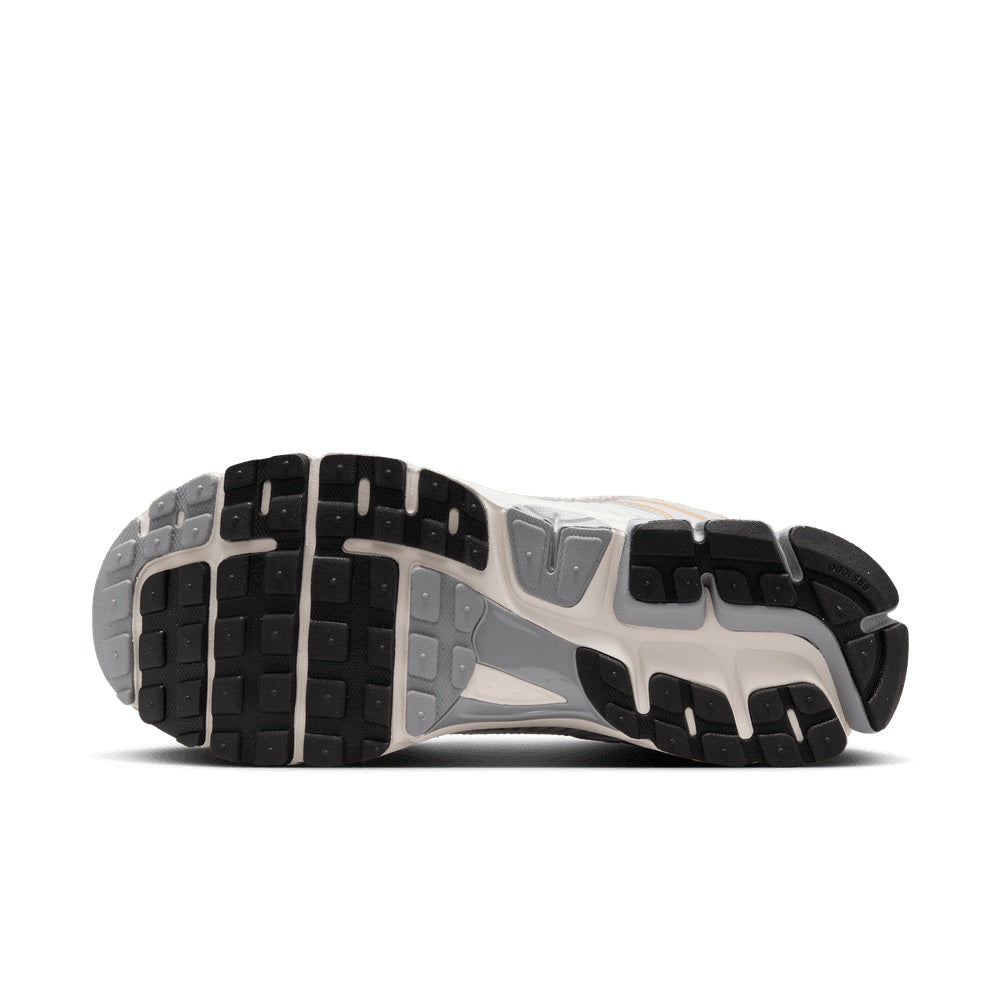 Shoe outsole bottom with black tread blocks and gray segments, side-to-side traction