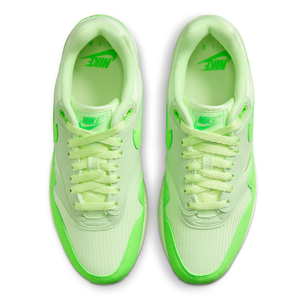 Nike Air Max 1 '87 sneakers, showing insoles with Nike text and lime accents