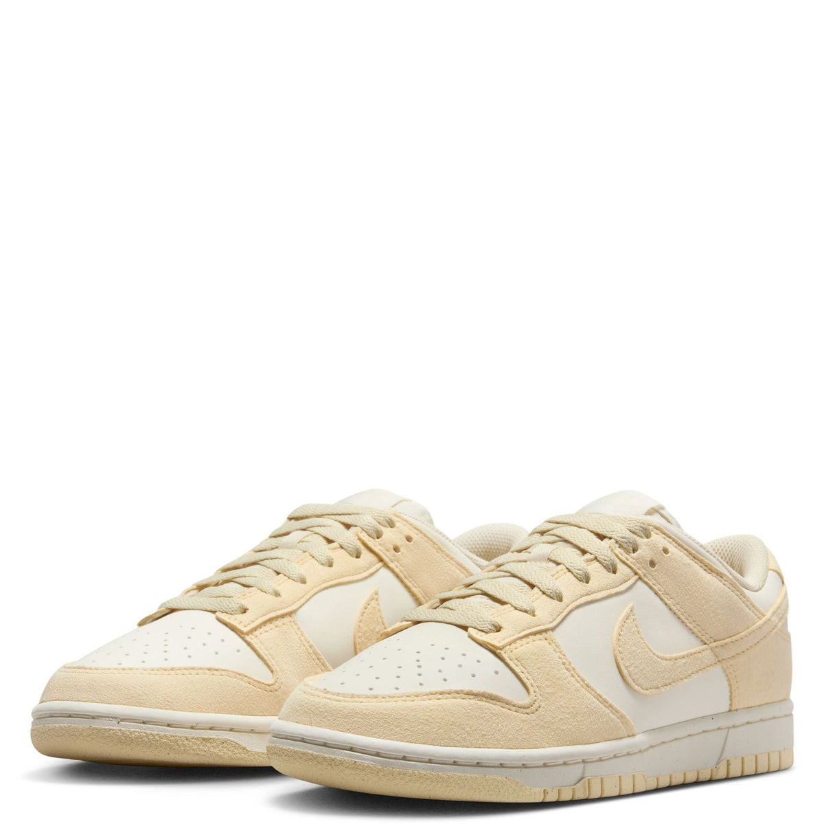 Pair of Nike Dunk Low sneakers in pale ivory and beige, front view with laces