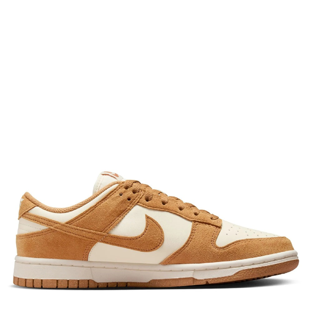 Women's Nike Dunk Low sneakers, side profile with tan laces and white toe box