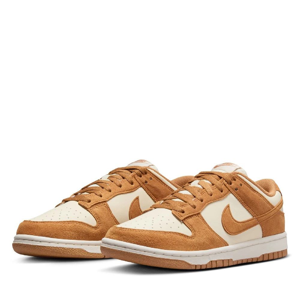 Pair of Women's Nike Dunk Low sneakers, tan suede with white panels and lace-up
