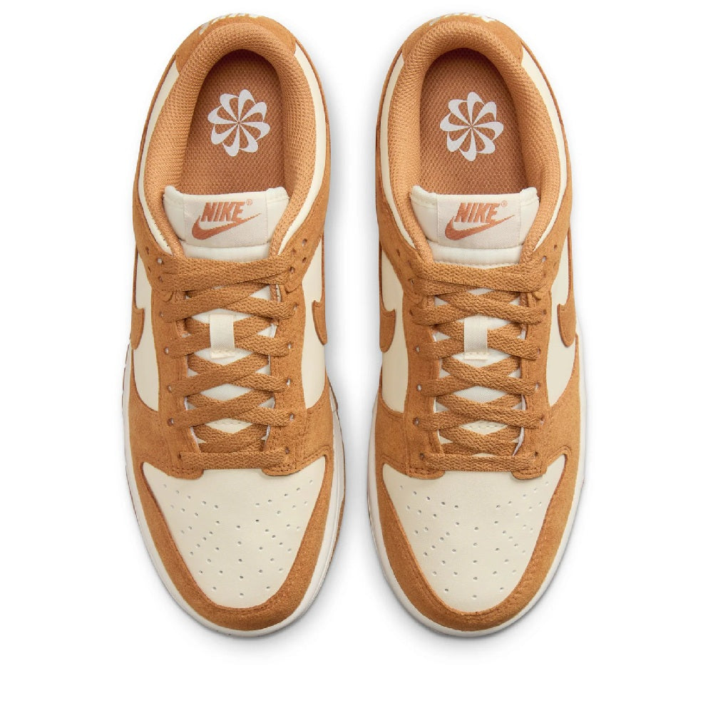 Women's Nike Dunk Low sneakers, tan and white uppers with Nike logo on tongue