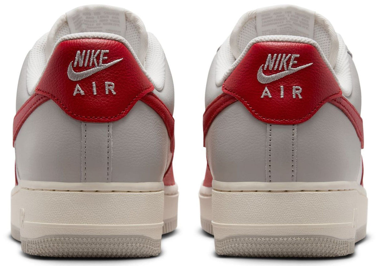 Back view of Nike Air Force 1 sneakers with red heel tab and Nike Air logo