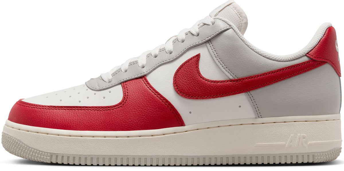 Low-top Nike Air Force 1 sneakers in white with red swoosh and trim