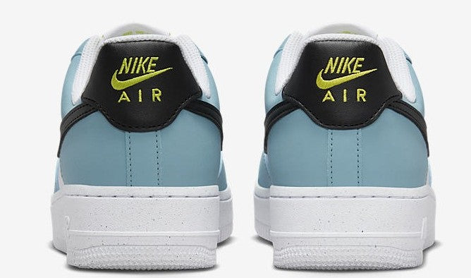 Nike Air Force 1 heel view with 'NIKE AIR' text, light blue uppers, black collar