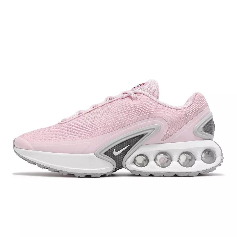 Nike women's running sneaker side view with pink upper and gray swoosh on white sole