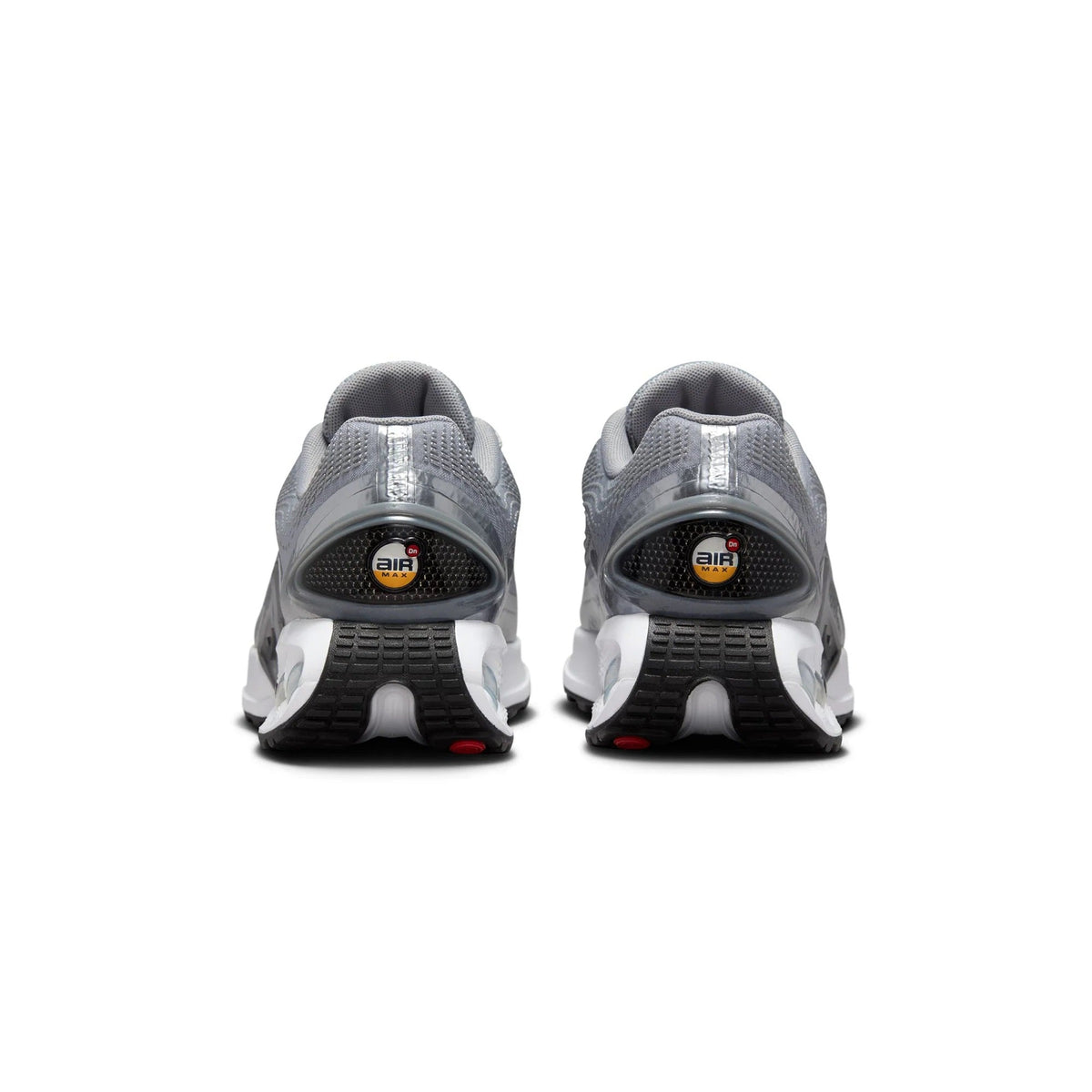 Pair of metallic silver Nike Air sneakers, rear view with Air logo and heel padding