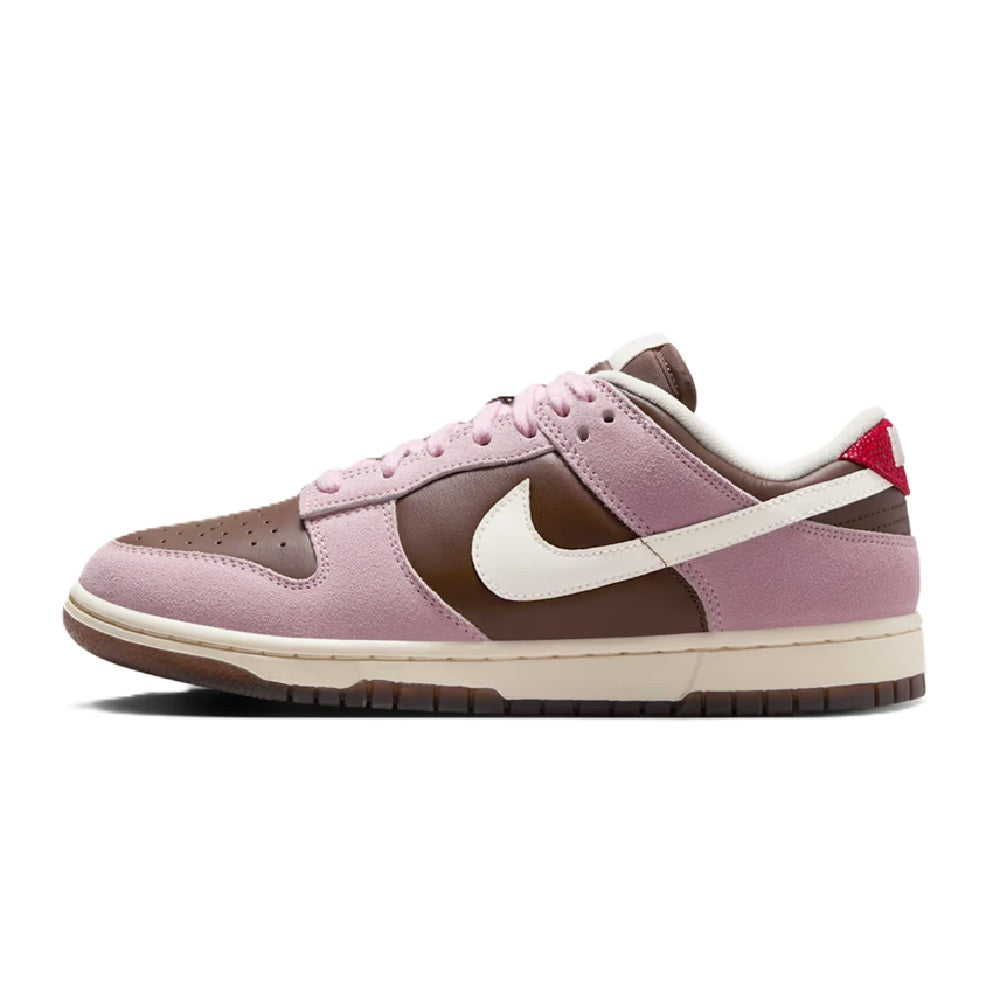 Nike Dunk Low low-top sneakers, mauve-pink with white panels and swoosh; red lace tag