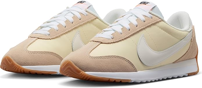 Pair of women's Nike low-top sneakers with lace-up beige and cream uppers.