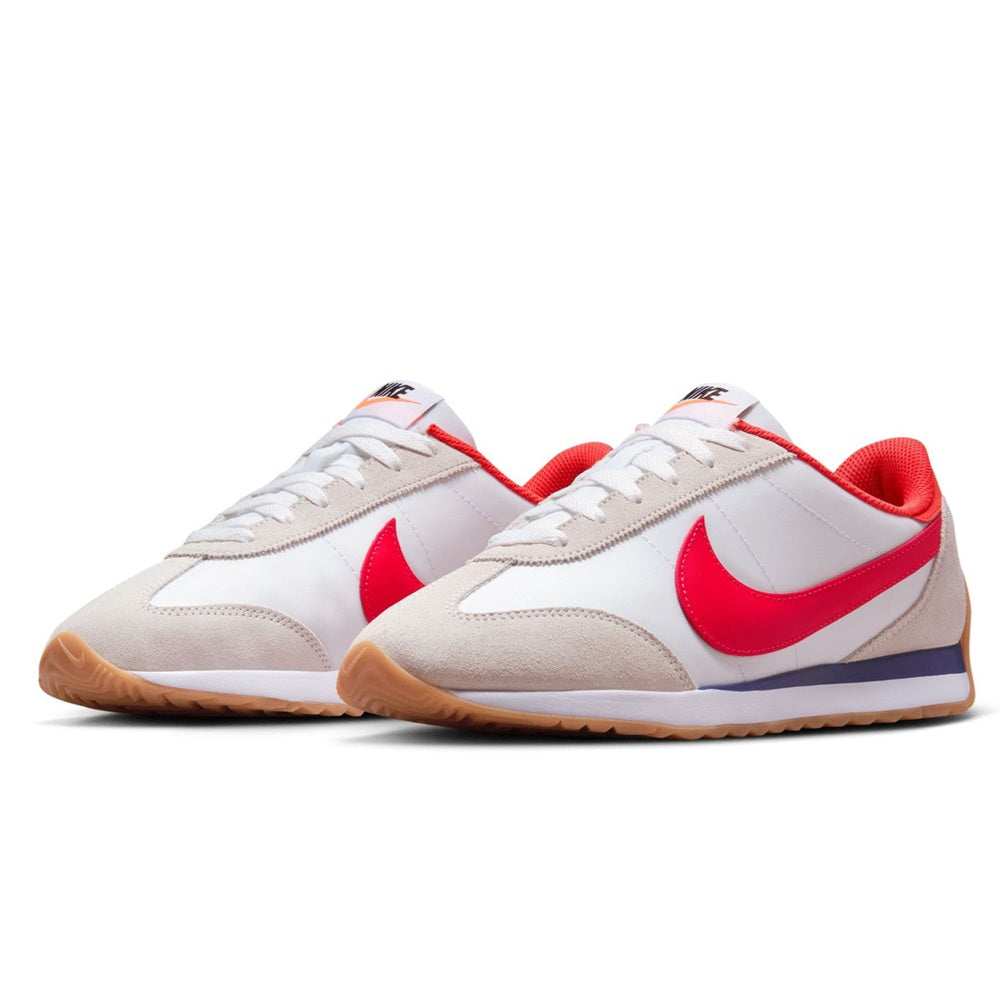 Nike women's low-top sneakers in white with red swooshes, beige suede, gum sole