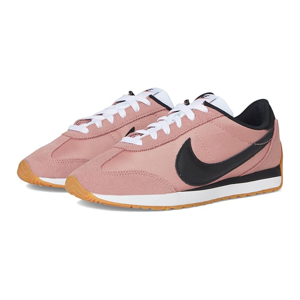 Women's Nike low-top sneakers in blush pink with black swoosh and white laces