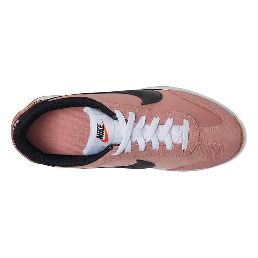 Women's Nike sneakers side view with blush pink suede and black collar detail