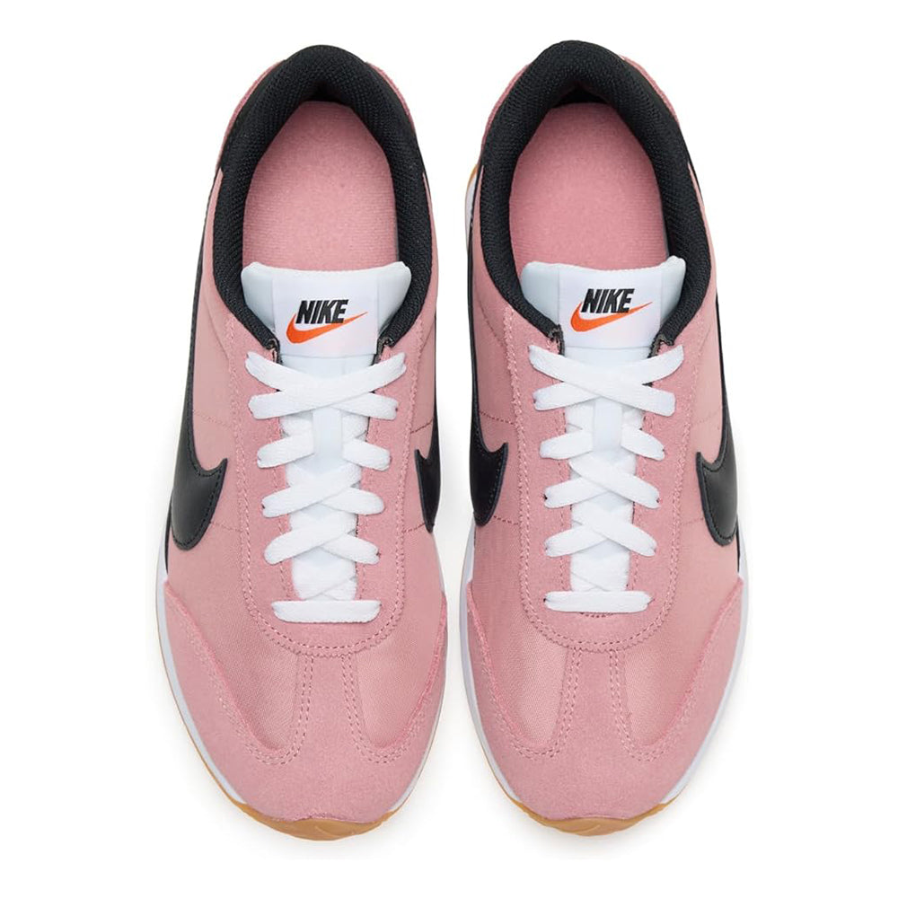 Women's Nike sneakers with blush pink uppers, white laces, black heel panels