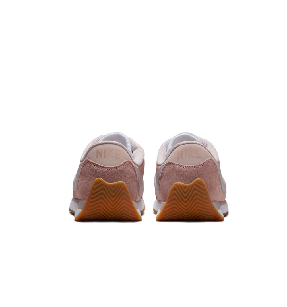 Women’s Nike sneakers heel view in dusty pink with gum heel panel and Nike branding