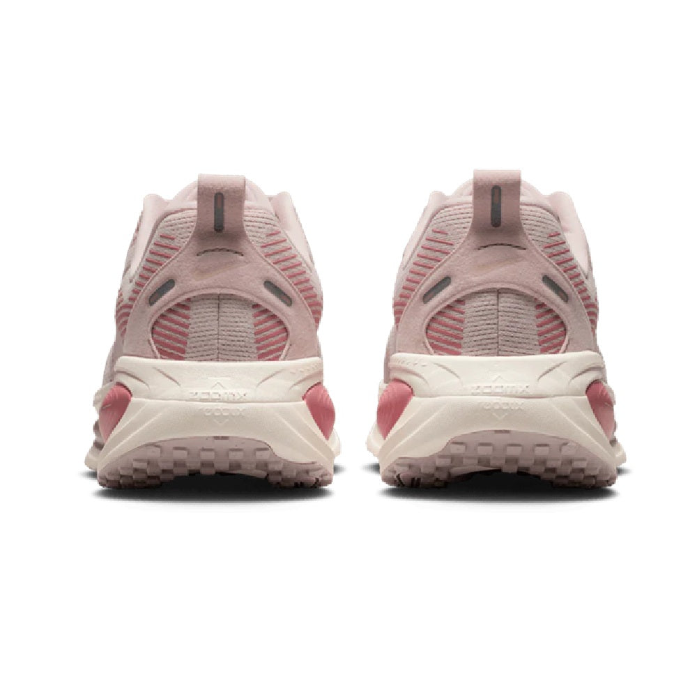 Women's Nike Vomero 18 heel view, pale pink with red trim and cushioned collar