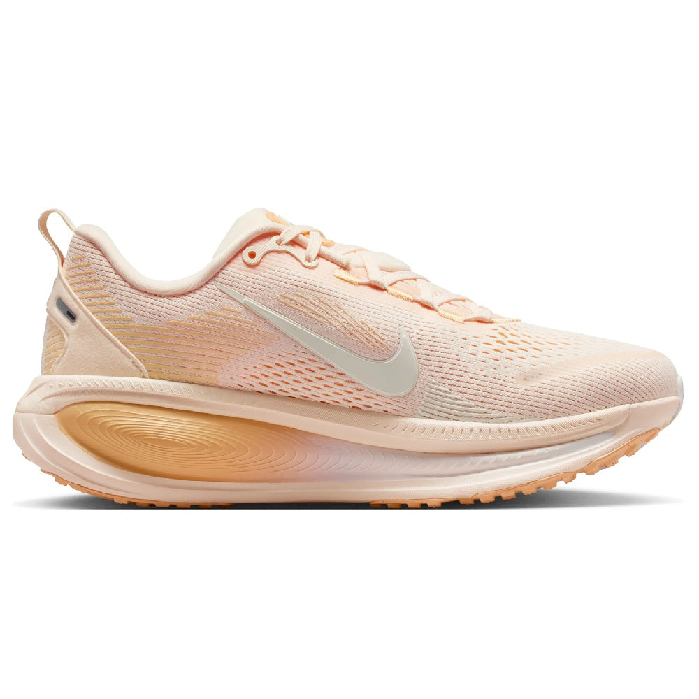 Nike Vomero 18 women's running shoe, side view in pale peach with swoosh and lace