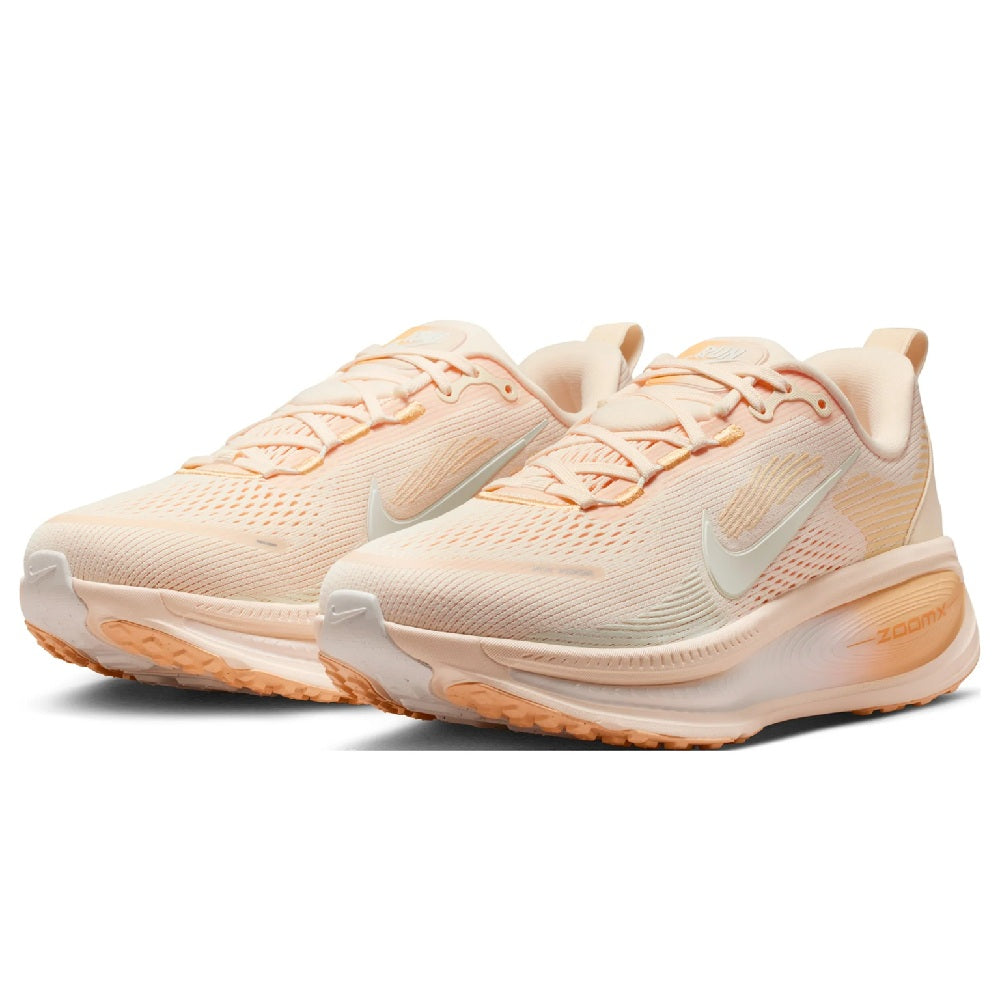 Nike Vomero 18 women's running shoe, front angle in pale peach with orange-tinted laces