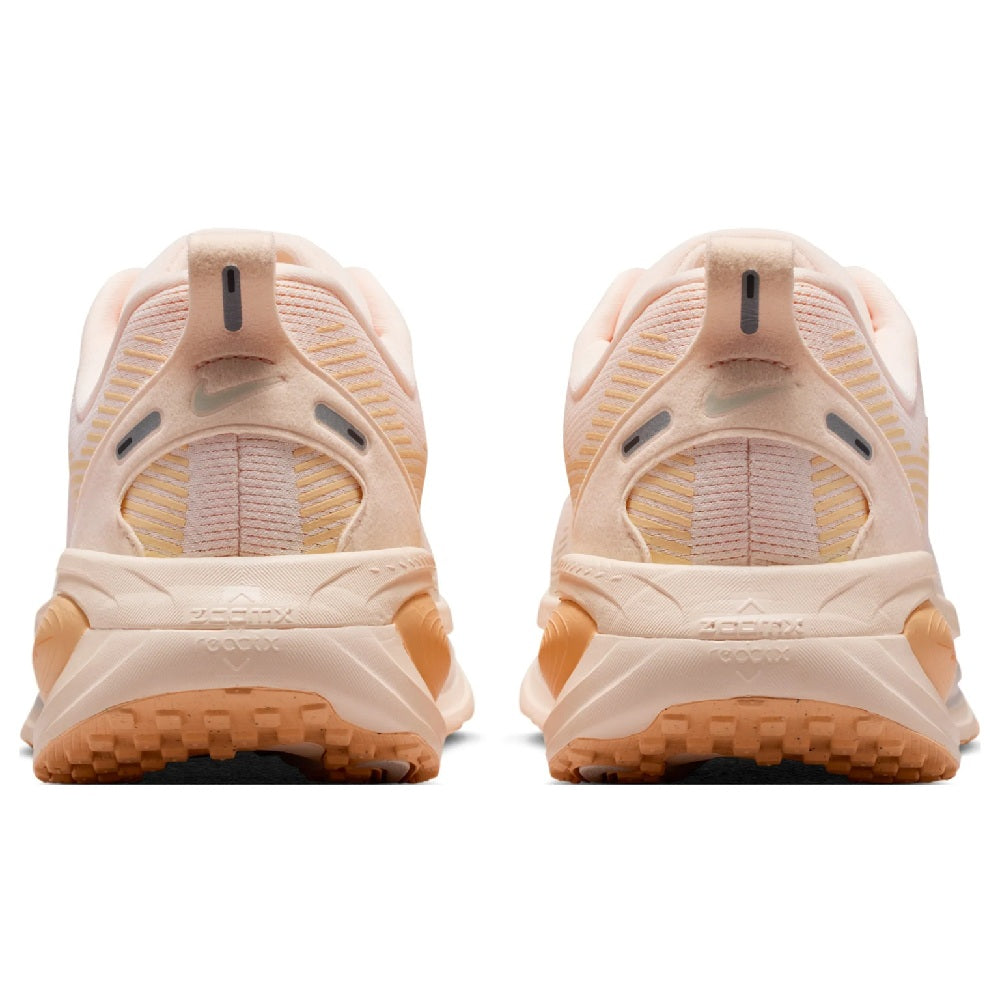 Nike Vomero 18 women's running shoe, heel view in pale peach with cushioned back and tab
