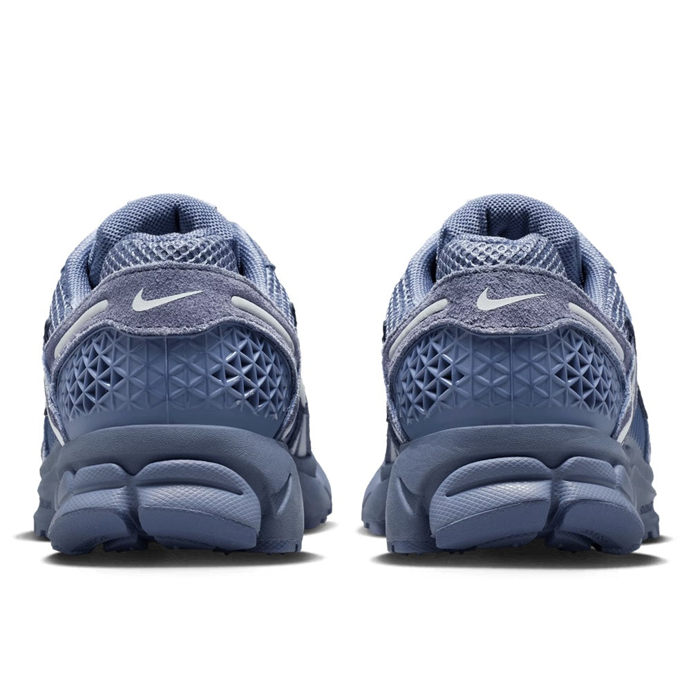 Nike Zoom Vomero 5 shoes, rear view showing blue heel, cushioning, and treaded outsole