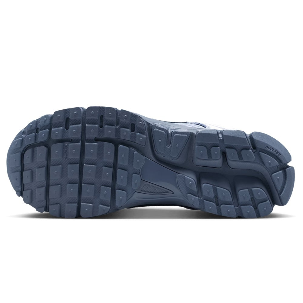 Nike Zoom Vomero 5 outsole view, dark blue rubber tread with molded traction blocks