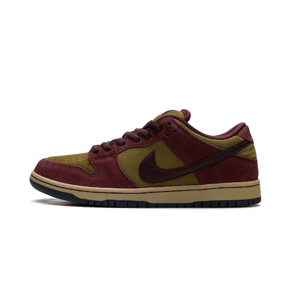 Low-top skate shoe in burgundy suede with olive overlays, Nike Swoosh, lace-up front