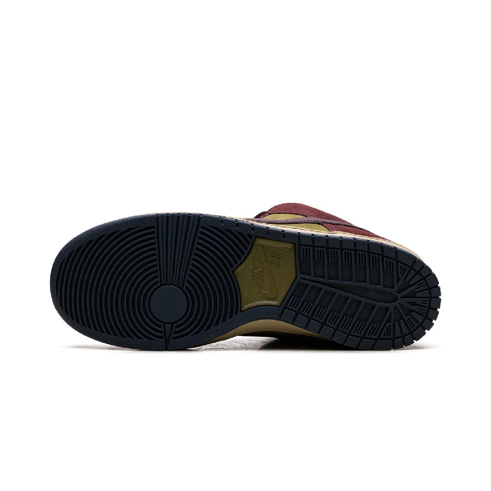 Outsole tread of burgundy and olive low-top skate shoe with dark rubber bottom